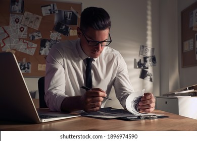 Detective Working At Desk In His Office