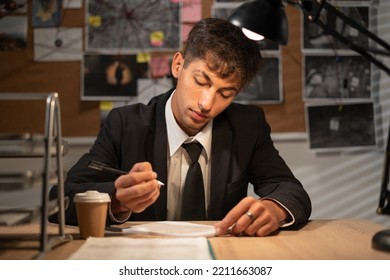 Detective Working At Desk In His Office, Evaluating Clues, Writing An Arrest Report