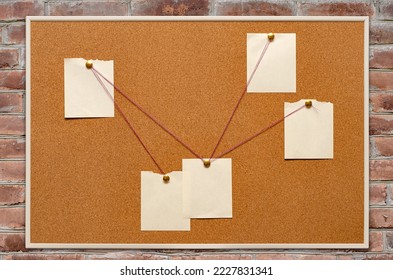 The detective's corkboard is hanging on a brick wall. Copy space. - Shutterstock ID 2227831341