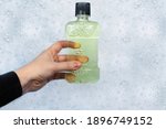 Detergent bottles float in the foam. The concept of the dangers of household chemicals. Laureate of sodium, parabens, sulfates and other chemical compounds in the composition. Mouthwash in a container