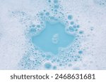 Detergent foam bubble on water. Blue background, Soap sud