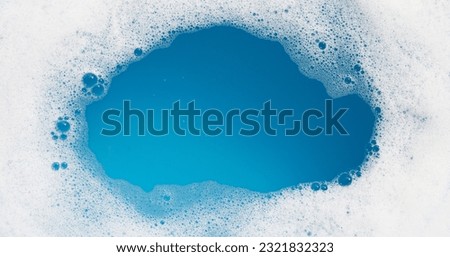 Detergent foam bubble on water. Blue background, Soap sud