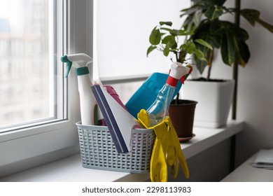 detergents, basket with cleaning supplies in home.