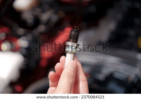 Deteriorated and blackened car spark plug