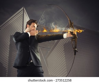 Determinated Businessman With Flaming Arrow Takes Aim