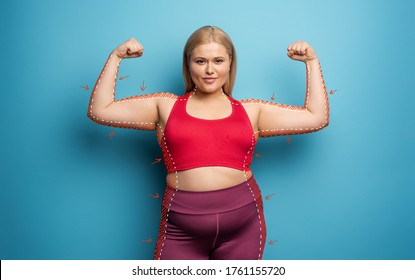 Determinated girl wants to remove fat and does gym at home. satisfied expression. cyan background - Shutterstock ID 1761155720
