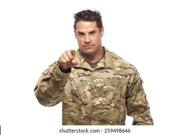 Determined army soldier pointing at camera in front of white background - Powered by Shutterstock