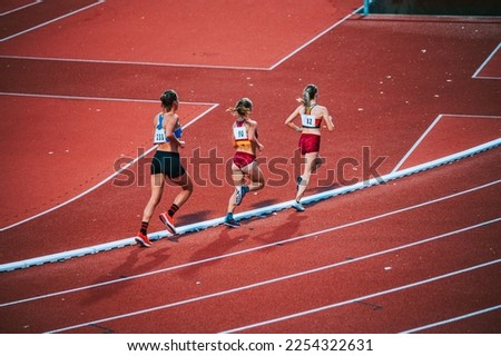 Determined female athletes legs pushing through the 5000m race on track, showcasing their athleticism, focus and physical fitness