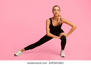 Determined Fitness Woman Doing Side Lunge Stretch Working Out In Studio Over Yellow Background. - Powered by Shutterstock