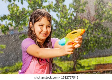 Determined Girl In Fun Water Gun Fight Game