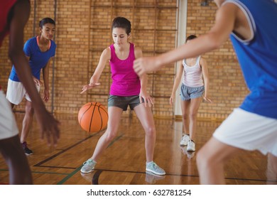 Determined High School Kids Playing Basketball In The Court