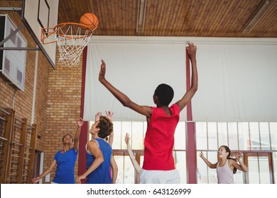 Determined High School Kids Playing Basketball In The Court