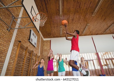 Determined High School Kids Playing Basketball In The Court