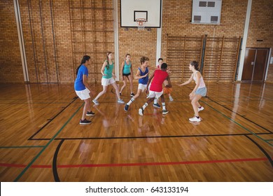 Determined High School Kids Playing Basketball In The Court