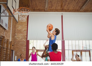 Determined High School Kids Playing Basketball In The Court