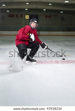 Determined Hockey Player Sprays Ice as he Makes Sharp Stop on Skates