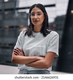 Determined to make it no matter the cost. Shot of an attractive young businesswoman standing alone in the office with her arms folded during a late shift. - Shutterstock ID 2146626931