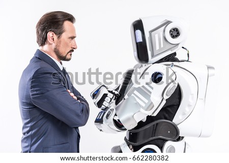 Determined male person looking at cyborg