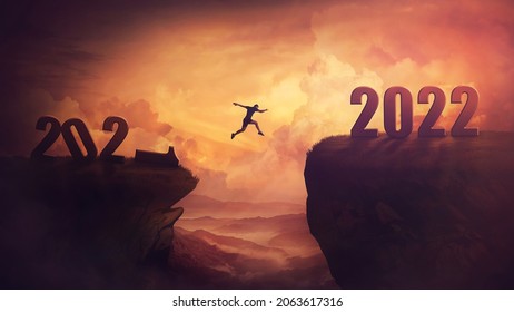 Determined man jump over a chasm obstacle to reach the new 2022 peak and let 2021 behind. Conceptual and surreal sunset scene, new year motivational background. Leader overcoming hurdles reach highs - Shutterstock ID 2063617316