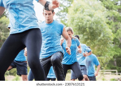 Determined man on boot camp obstacle course - Powered by Shutterstock