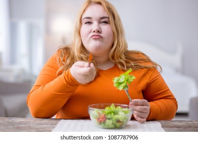 I Am Determined. Serious Stout Woman Sitting At The Table And Having Healthy Breakfast