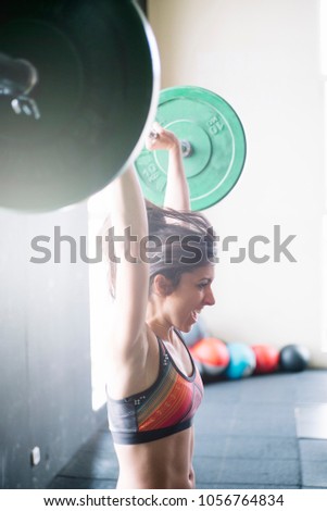 Similar – young adult trained woman concentrate at her excercise in gym