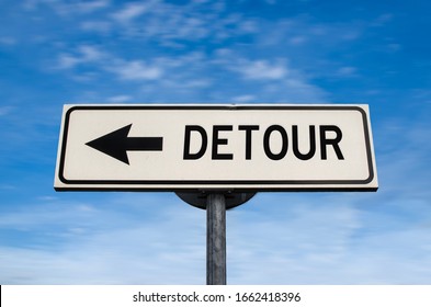 Detour road sign, arrow on blue sky background. One way blank road sign with copy space. Arrow on a pole pointing in one direction.