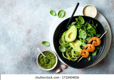 Detox Buddha Schüssel mit Avocado, Spinat, Grün, Zucchini Nudeln, gegrillten Garnelen und Pesto-Sauce. Gemüsepflanze Low Carb Lunch Schüssel. 