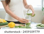 Detox juice concept, Hand of woman, girl holding bottle making green vegetable smoothie pouring in glass for diet at home kitchen, drinking healthy meal food for weight loss. Lifestyle vegan nutrition