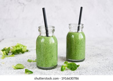 Detox menu. Smoothie with spinach on a concrete background in a jar. - Powered by Shutterstock