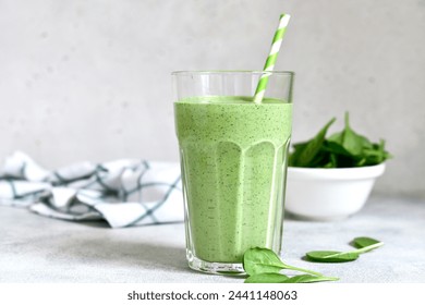 Detox spinach smoothie in a tall glass on white slate, stone or concrete background. Top view with copy space. - Powered by Shutterstock