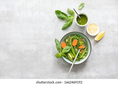 Detox Vegetable Spring Soup, Green Minestrone Inspired Recipe, Overhead View On Ready To Eat Served With Pesto And Parmesan Dish, Copy Space For A Text