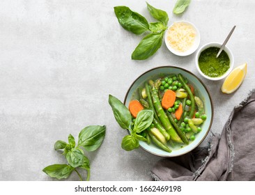 Detox Vegetable Spring Soup, Green Minestrone Inspired Recipe, Overhead View On Ready To Eat Served With Pesto And Parmesan Dish, Copy Space For A Text