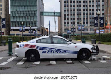 Detroit, MI - September 2019: Detroit police car in front of Comerica Park, with the Fox theater and Fillmore in the background. Law enforcement, DPD, security, 911, emergency.
