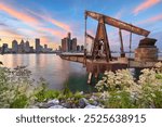 The Detroit, Michigan, USA skyline as seen from across the Detroit River in Windsor, Ontario, Canada at dusk.