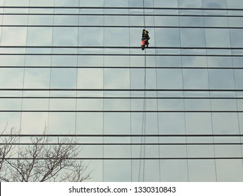  Detroit, Mich./USA-Feb. 22, 2019: A Lone Window Washer Works On The Side Of A Glass Office Tower That Houses The American Axle & Manufacturing Company Headquarters.                             