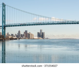 DETROIT, MI/USA - JANUARY 29, 2016: Ambassador Bridge Reflection In An Icy Detroit River, From Riverside Park. Visible: GM Renaissance Center And Cobo Center.