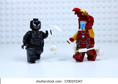 DETROIT, USA - APRIL 11, 2020: Venom attacks Iron man. Lego mini-figures. Venom wraps his web around Tony Stark.