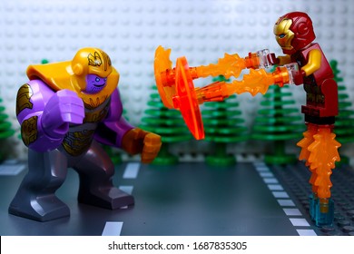 DETROIT, USA - MAR 30, 2020: Lego Iron Man Attacking Thanos Using Fire Power.