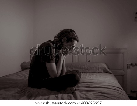 Devastated millennial man crying sad feeling hurt and hopeless suffering Depression. Depressed teenager victim of bullying or abuse sitting on bed alone in despair at night. In teenage Mental health.