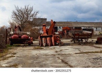 Devastation and decline in the agro-industrial sector. Cemetery of old rusty agricultural machinery. Industrial area. Background