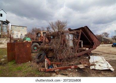 Devastation and decline in the agro-industrial sector. Cemetery of old rusty agricultural machinery. Industrial area. Background