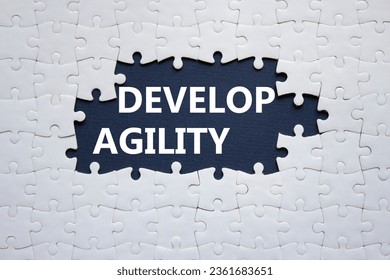 Develop agility symbol. Concept word Develop agility on white puzzle. Beautiful dark blue background. Business and Develop agility concept. Copy space - Shutterstock ID 2361683651