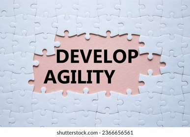 Develop agility symbol. Concept word Develop agility on white puzzle. Beautiful pink background. Business and Develop agility concept. Copy space - Shutterstock ID 2366656561