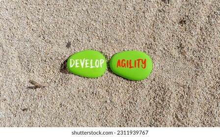 Develop agility symbol. Concept words Develop agility on beautiful green stone on a beautiful sand sea beach background. Business, support and develop agility concept. Copy space. - Shutterstock ID 2311939767