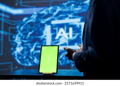 Developer analyzing complex AI brain models on green screen tablet. IT specialist using machine learning software on chroma key device to develop artificial intelligence technology