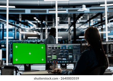 Developer in data center at green screen PC uses AI for machine learning workloads. IT specialist in server hub uses artificial intelligence on chroma key computer to perform demanding computing tasks