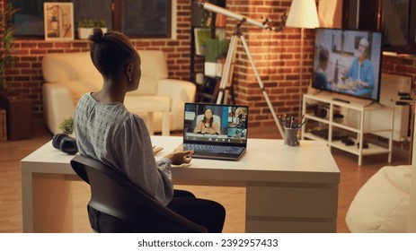 Developer discussing on videocall about new ideas for online project, creating freelance career from home office. African american woman using internet meeting connection.