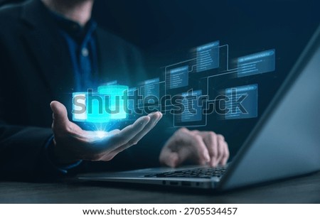 A developer holding a glowing hologram of an SQL database schema with relational tables and links, illustrating data modeling, system architecture, and modern database management for IT solutions.