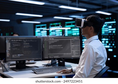 Developer immersed in virtual reality in server hub, doing units maintenance. Technician using VR headset to optimize servers performance, checking operations in data center - Powered by Shutterstock